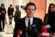 Jeremie Assous addressing the press ahead of the trial in Paris court (Image via Mohamad Salaheldin Abdelg Alsayed/Anadolu/Getty)